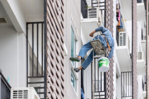Exterior paint and leak repair technician builder, rope rappelling to repair buildings outside crack wall repainting and fix water leakage